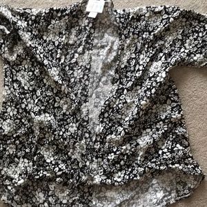 Girl Lularoe black back ground white flowers